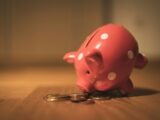pink pig coin bank on brown wooden table