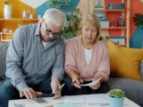 Elderly couple reviewing documents at home