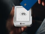 A person holding a credit card in their hand