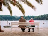 coupe sitting on white bench near body of water