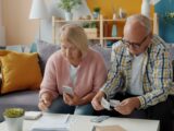 Elderly couple managing finances at home