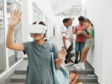 Group of kids using VR in school hallway, exploring technology and learning.