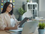 Woman working with documents at office desk