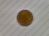 A close-up of a coin with a profile