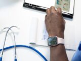 a hand holding a smart watch