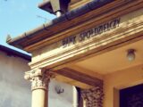 Detailed view of a historic Polish bank facade with classic architectural columns.