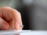 A close up of a person writing on a piece of paper