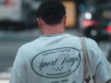 Man walking across street with cars in background.