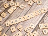 scrabble tiles spelling the word innovation on a wooden surface