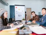 A group of young professionals brainstorming ideas in a startup office setting.