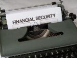 a close up of a typewriter with a financial security sign on it