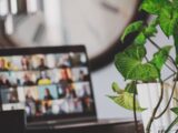 laptop showing video call near houseplant
