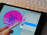 person holding white pen and black ipad