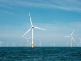 a group of wind turbines in the ocean