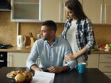 Couple sitting at kitchen table with pastries