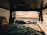 a bedroom with a bed and a view of the ocean