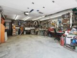 a garage filled with lots of clutter and tools