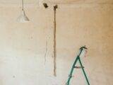 gray pendant lamp beside wall