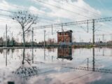 a building sitting in the middle of a flooded area