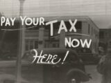 a sign that says pay your tax now here