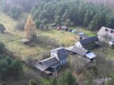 an aerial view of a house in the woods
