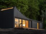 black metal trailer house near green trees