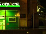 OTP bank branch at night with illuminated sign
