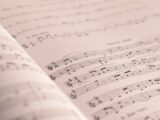 an open book with musical notes on it