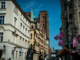 European buildings stand tall against a bright blue sky