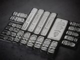 a pile of silver bars sitting on top of a table