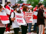 people holding white and red banner